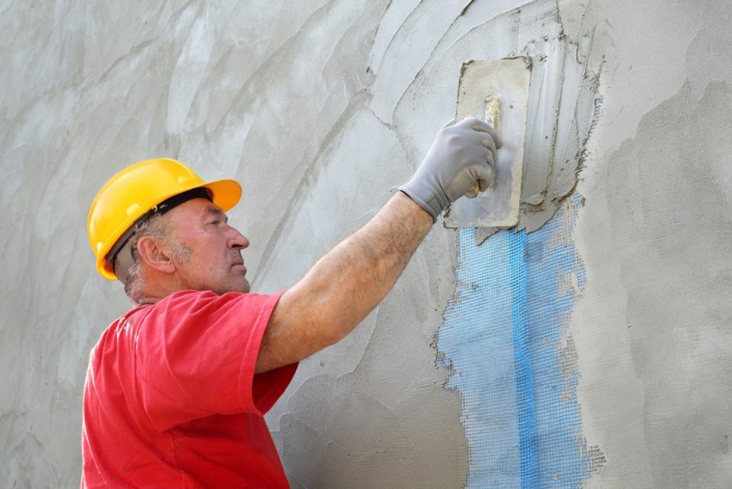 stock-photo-worker-spreading-mortar-over-styrofoam-insulation-and-mesh-with-trowel-199748270-transformed